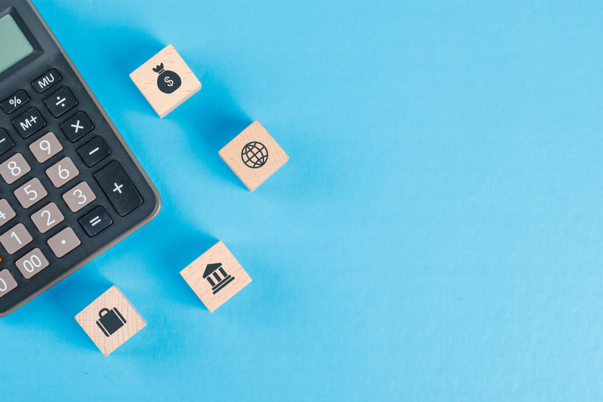 https://www.cfoservices.gr/wp-content/uploads/2022/11/financial-concept-with-icons-wooden-cubes-calculator-blue-table-flat-lay.jpg